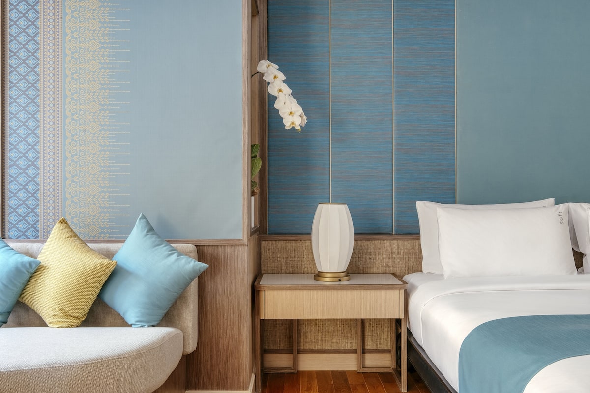 Relax in a stylish room with a comfortable bed, sofa, and modern amenities.