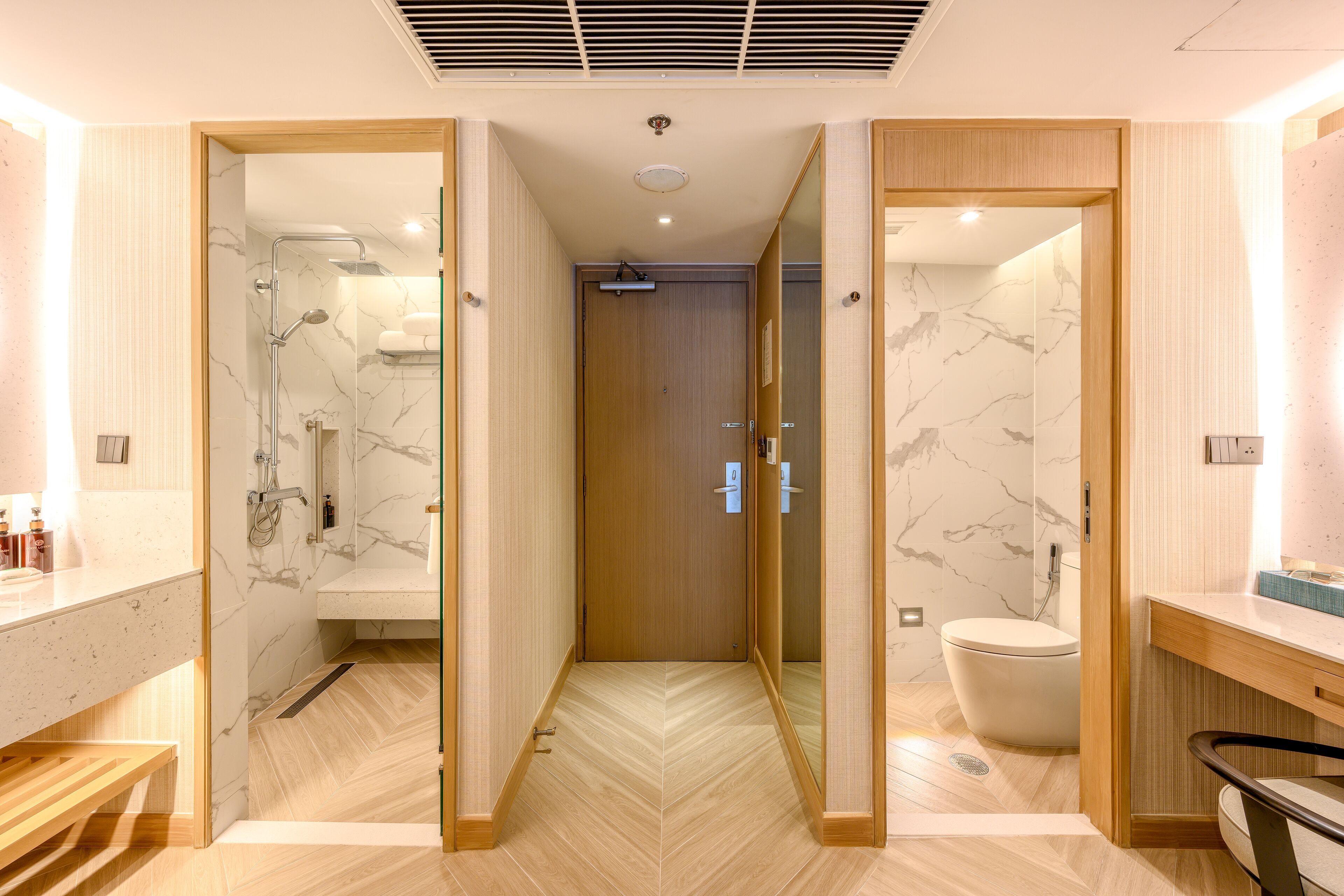 A modern bathroom with a shower, toilet, and vanity.