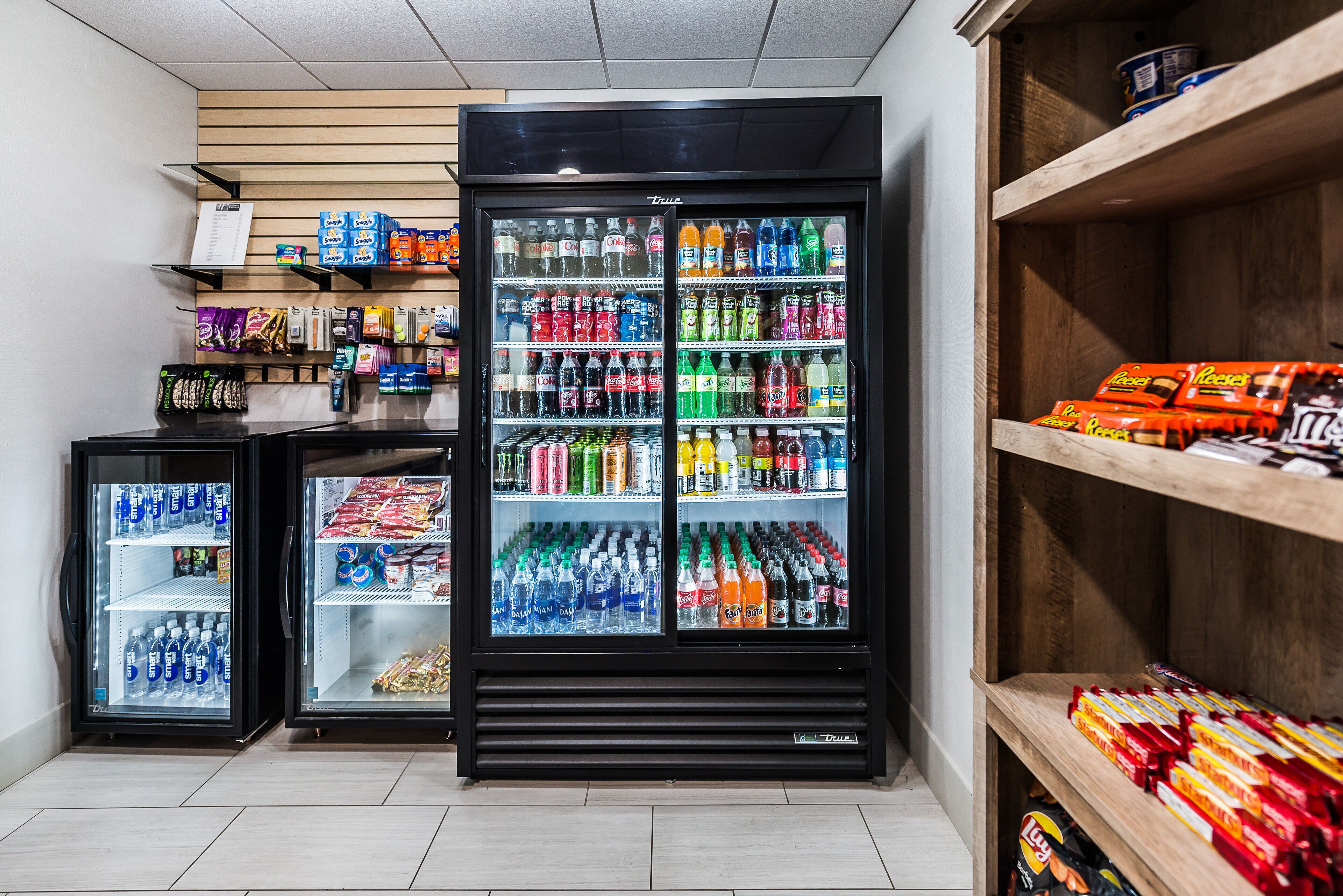 A refrigerated display case with various beverages and snacks.