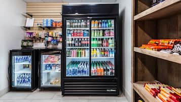 A refrigerated display case with various beverages and snacks.