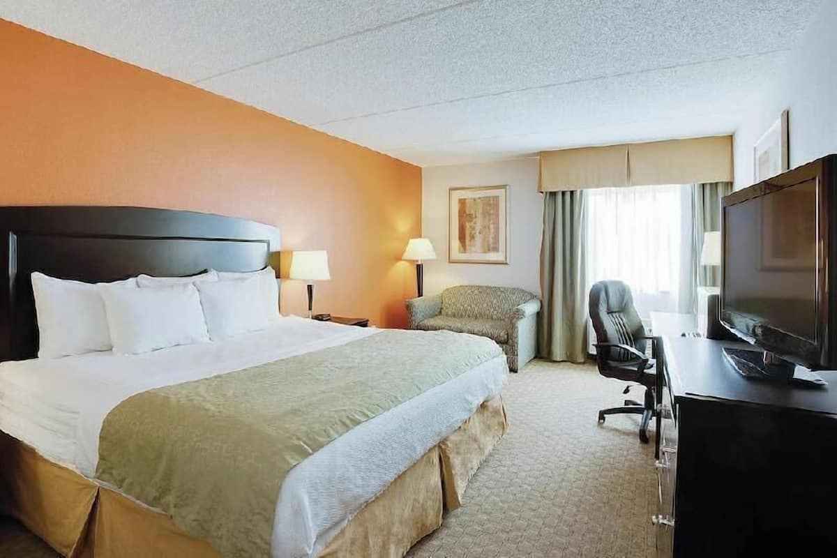 Premium bedding, desk, laptop workspace, iron/ironing board