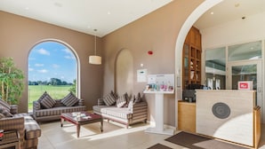 A spacious living area with a sofa set, a coffee table, and a reception desk. - Best Western Lamphey Court Hotel & Spa (Pembroke)