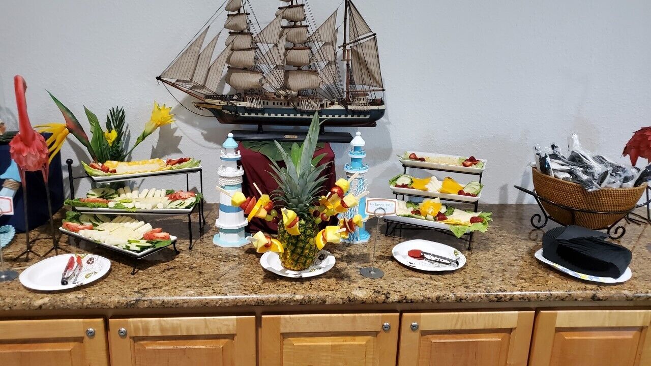 Un buffet proposant une variété de plats et agrémenté d’une maquette de bateau décorative.