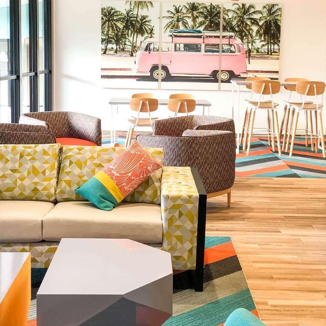 A modern lounge area with a sofa, chairs, and a coffee table.