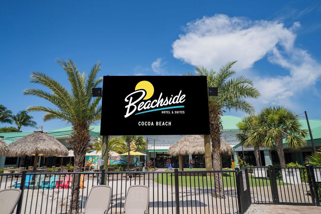 A sign for Beachside Hotel & Suites at Cocoa Beach.