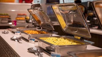 A buffet with various food options, including scrambled eggs and other dishes, with serving utensils and labels.