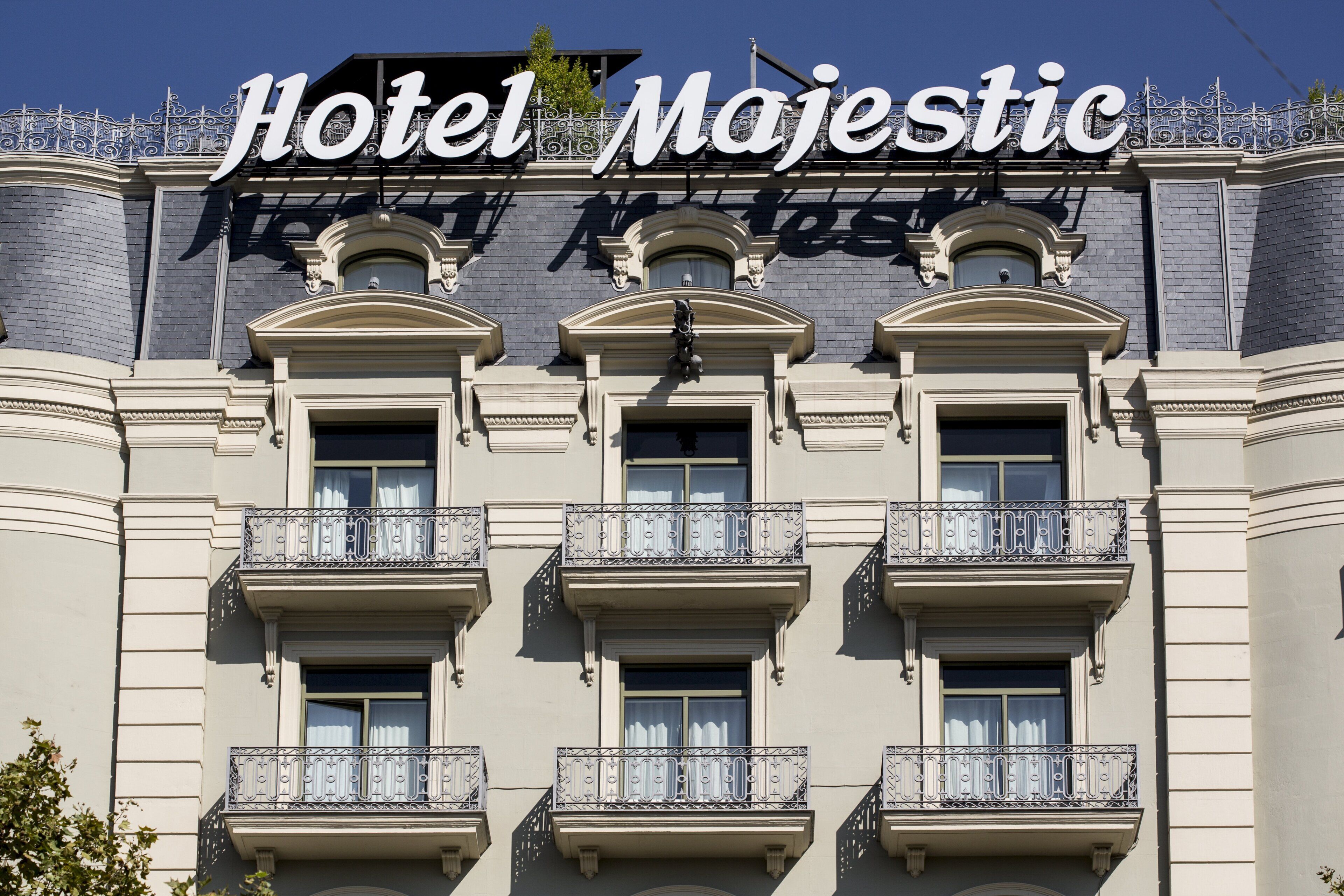 Hotel Majestic with a classic architectural style, featuring ornate balconies and a prominent sign.