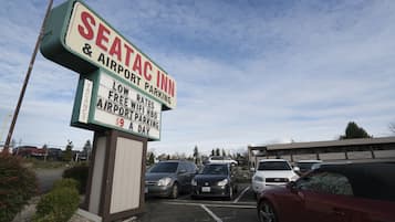 A parking lot with a sign for Seataac Inn & Airport Parking.