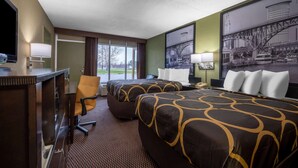A hotel room with two beds, a desk with a computer, a chair, and a large window with a view of the outside. - Super 8 by Wyndham Perrysburg/Toledo (Perrysburg)