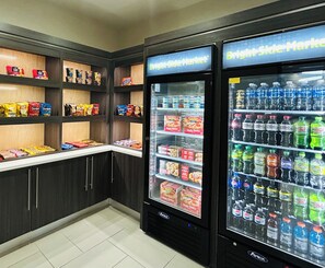 A self-service snack and drink vending area with various snacks and bottled beverages. - La Quinta Inn by Wyndham Columbia SE / Fort Jackson (Columbia)