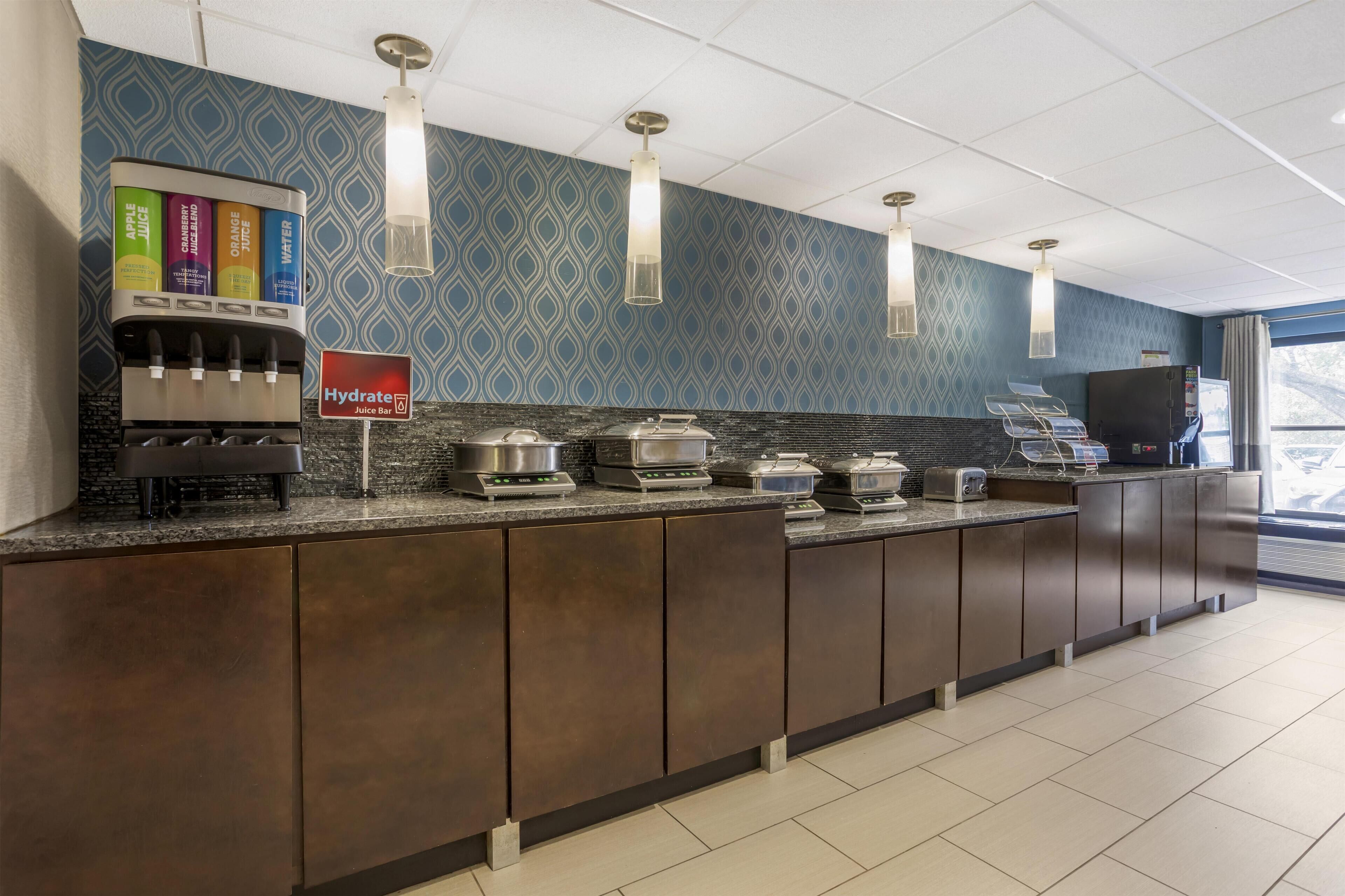 A hotel juice bar with a variety of juices, a scale, and a coffee machine.