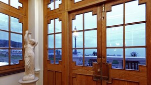 A wooden door with a statue of a woman on the left. - Imperial Hotel (Llandudno)