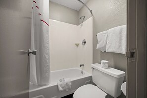 A bathroom with a bathtub, toilet, and shower. - Red Roof Inn Detroit - Royal Oak/ Madison Heights (Madison Heights)
