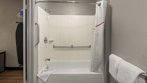 A bathroom with a walk-in shower, a towel rack, and a toilet. - Red Roof Inn Detroit - Royal Oak/ Madison Heights (Madison Heights)