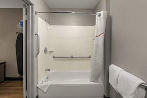 A bathroom with a walk-in shower, a towel rack, and a toilet. - Red Roof Inn Detroit - Royal Oak/ Madison Heights (Madison Heights)