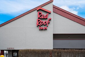 Experience the Red Roof Inn's simple, modern design with a prominent red roof and bold entrance.