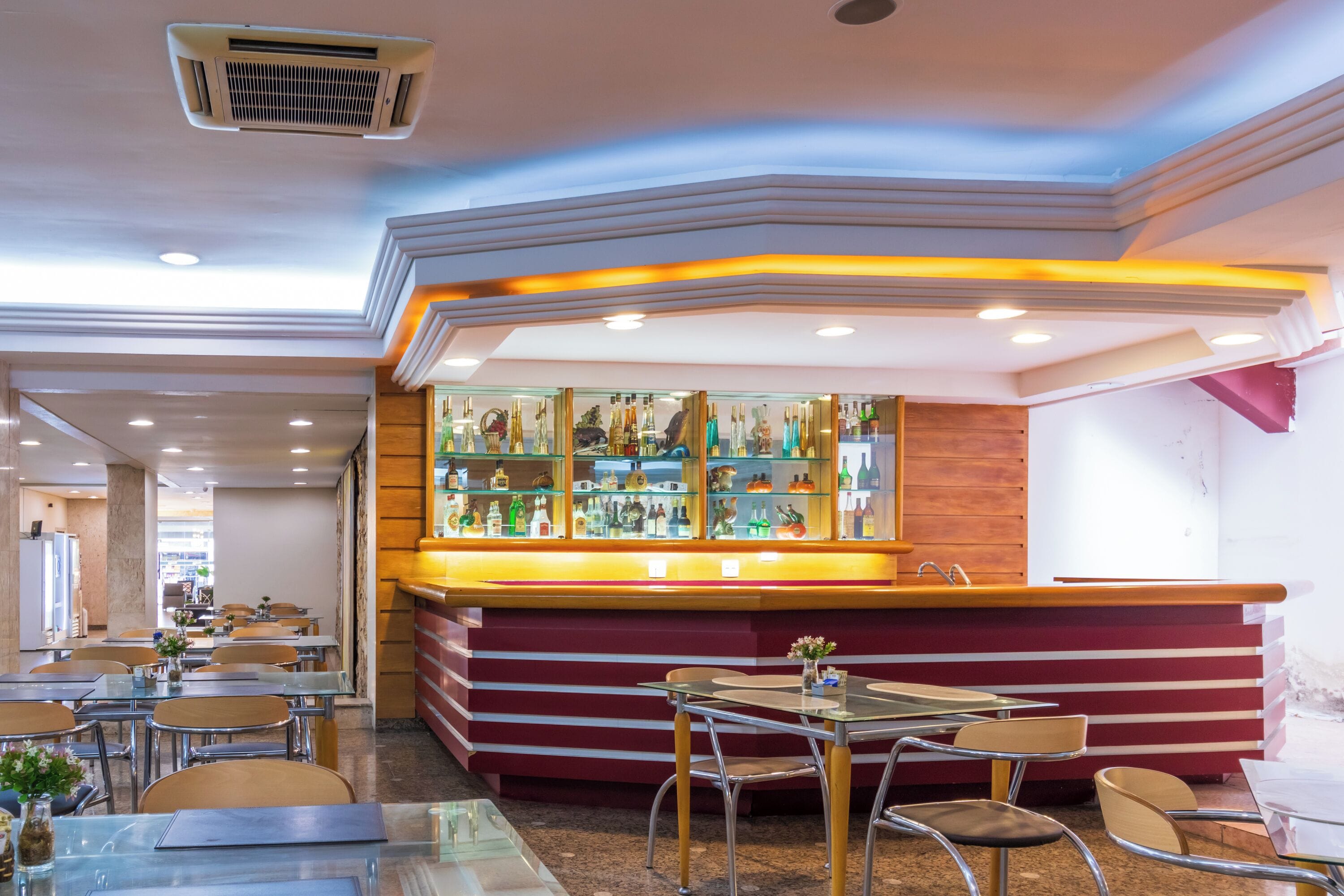 Un restaurant doté d’un bar, de tables et de chaises.