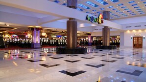 A spacious atrium with a high ceiling featuring recessed lighting and a central column. - The Aquarius Casino Resort, BW Premier Collection (Laughlin)