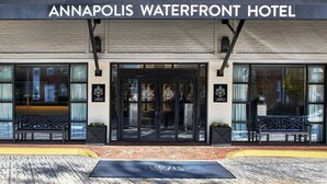 The exterior of the Annapolis Waterfront Hotel with a clear entrance, large windows, and a bench outside. - Annapolis Waterfront Hotel, Autograph Collection (Annapolis)