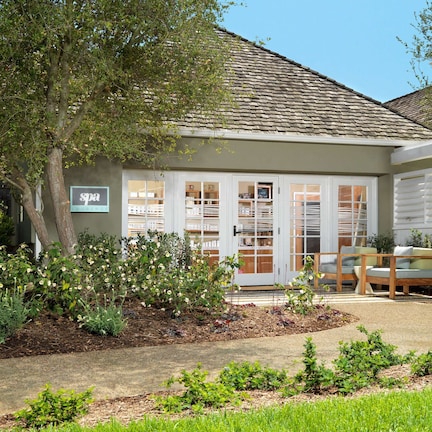 A spa with a wooden deck and outdoor seating.