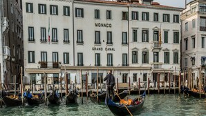 A canal with gondolas and a building labeled "MONACO & GRAND CANAL". - Hotel Monaco & Grand Canal (Venice)