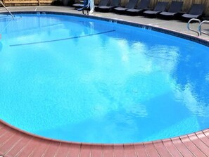 Seasonal outdoor pool, open 9 AM to 10 PM, pool umbrellas, pool loungers