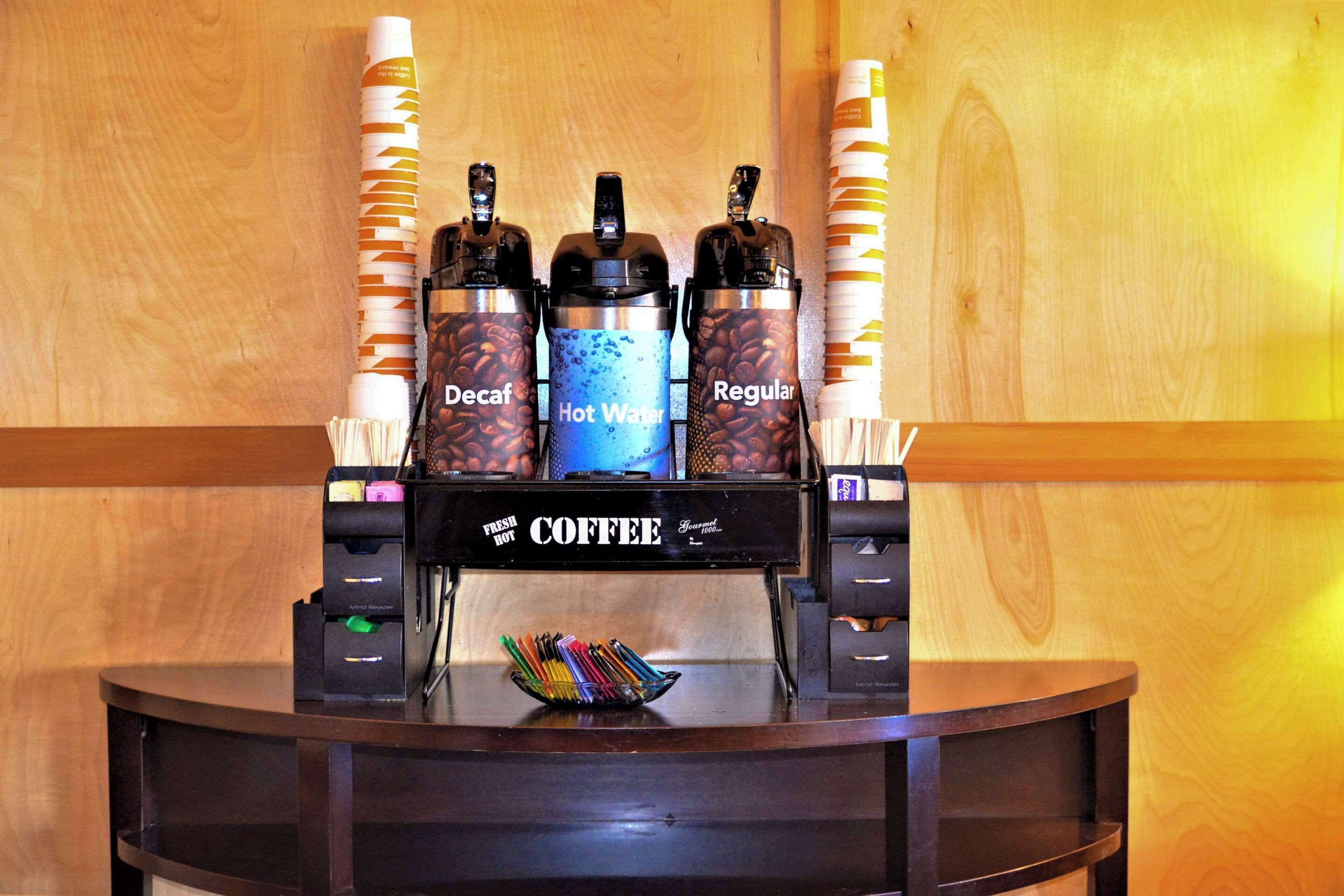 A coffee machine with three dispensers labeled Decaf, Hot Water, and Regular.