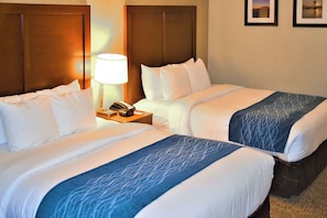 Premium bedding, desk, laptop workspace, blackout drapes