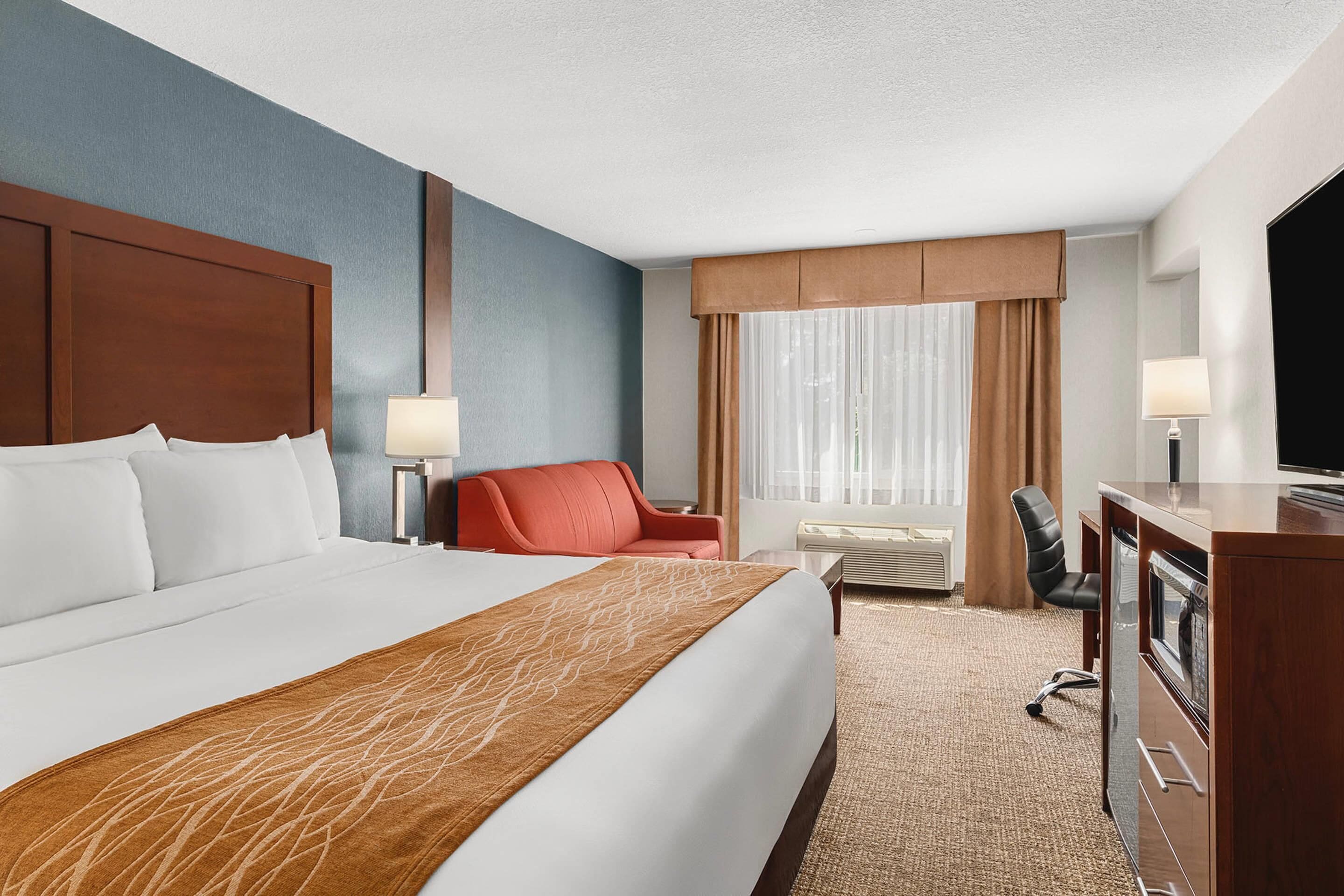 Premium bedding, desk, laptop workspace, blackout drapes