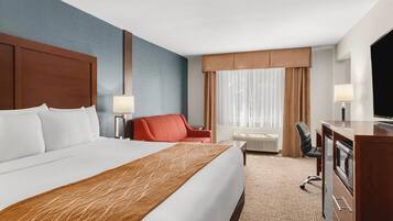 Premium bedding, desk, laptop workspace, blackout drapes