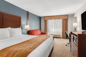 Premium bedding, desk, laptop workspace, blackout drapes