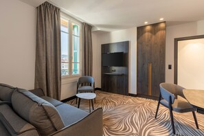 Suite, 1 King Bed, Non Smoking (Larger Room;with Sofabed) | Living area | Flat-screen TV, offices