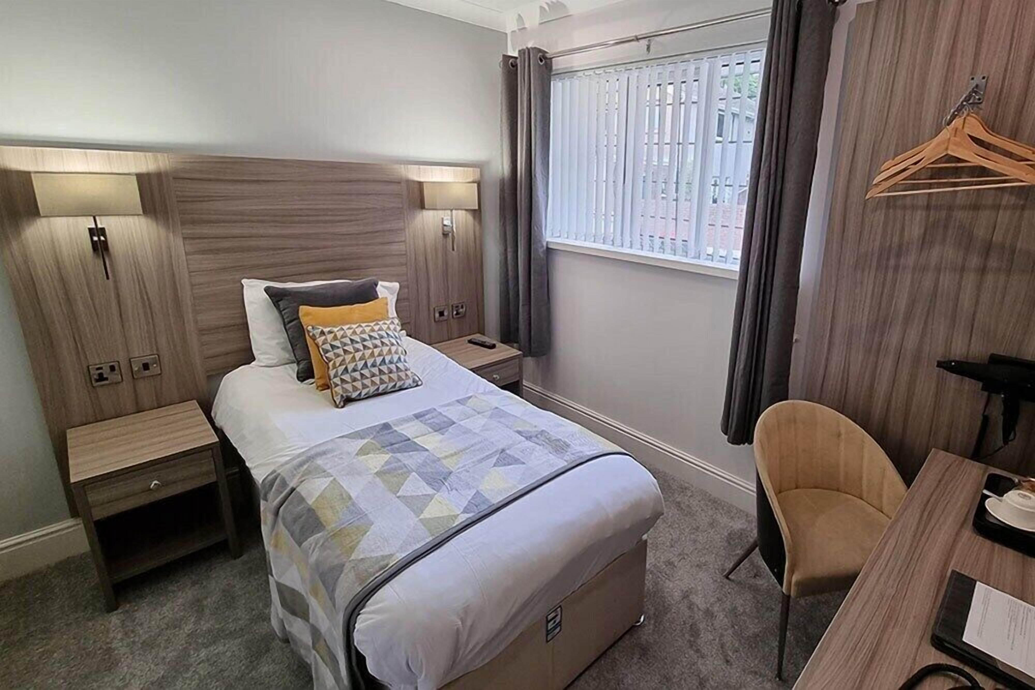 Premium bedding, desk, laptop workspace, iron/ironing board