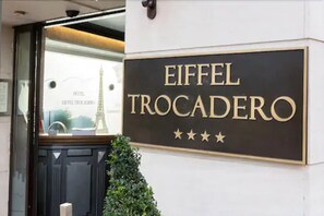 A hotel sign with the name "Eiffel Trocadero" and four stars.