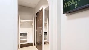 A hotel corridor with a wooden wardrobe, a control panel, and a sign on the wall. - B&B Hotel Napoli (Naples)