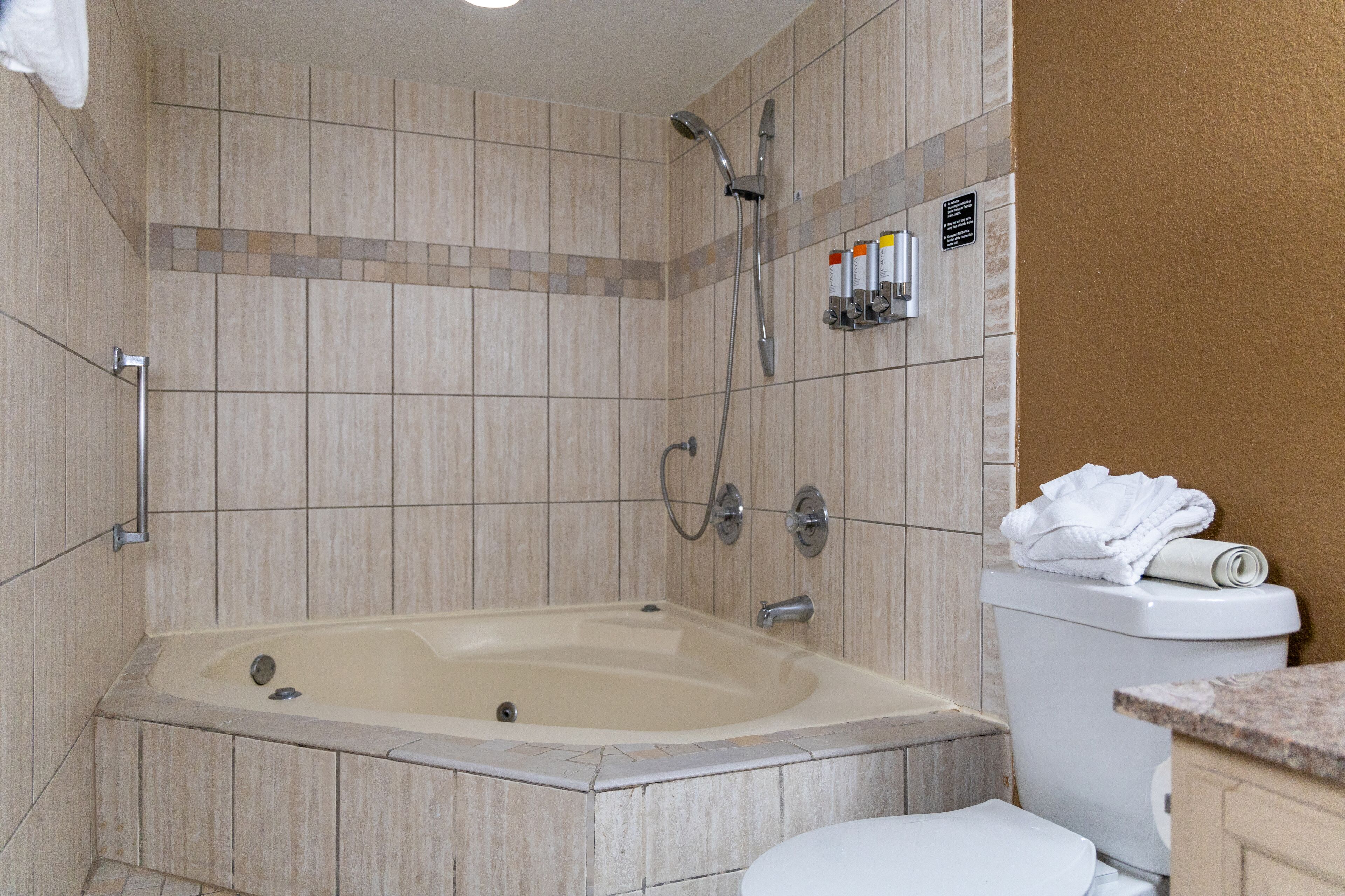 A bathroom with a bathtub, toilet, and shower.