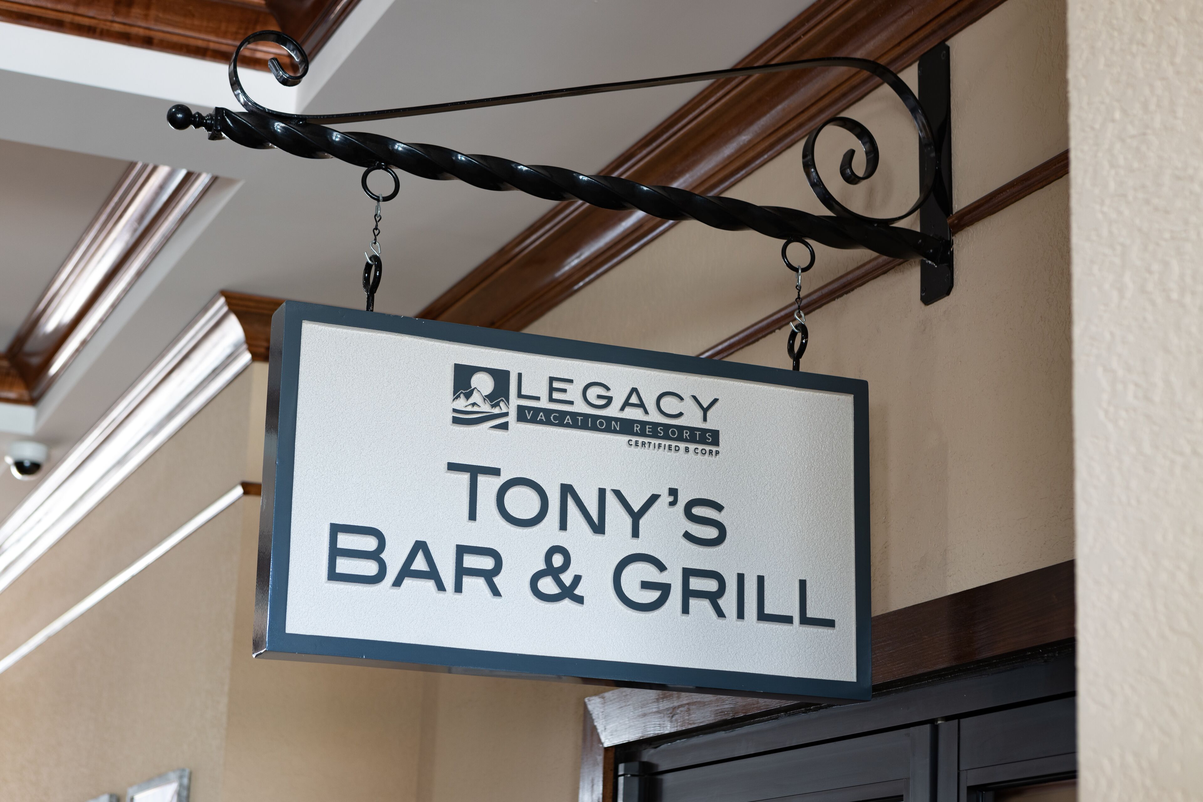 A sign for "Legacy Vacation Resorts" indicating "Tony's Bar & Grill".
