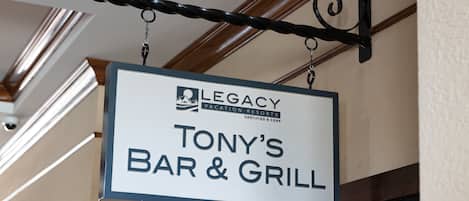 A sign for "Legacy Vacation Resorts" indicating "Tony's Bar & Grill".