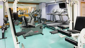 A gym with various exercise machines, including treadmills and weight stations.