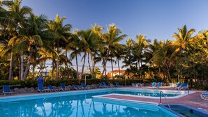 A swimming pool with lounge chairs and palm trees. - Marina Del Mar Resort and Marina (Key Largo)
