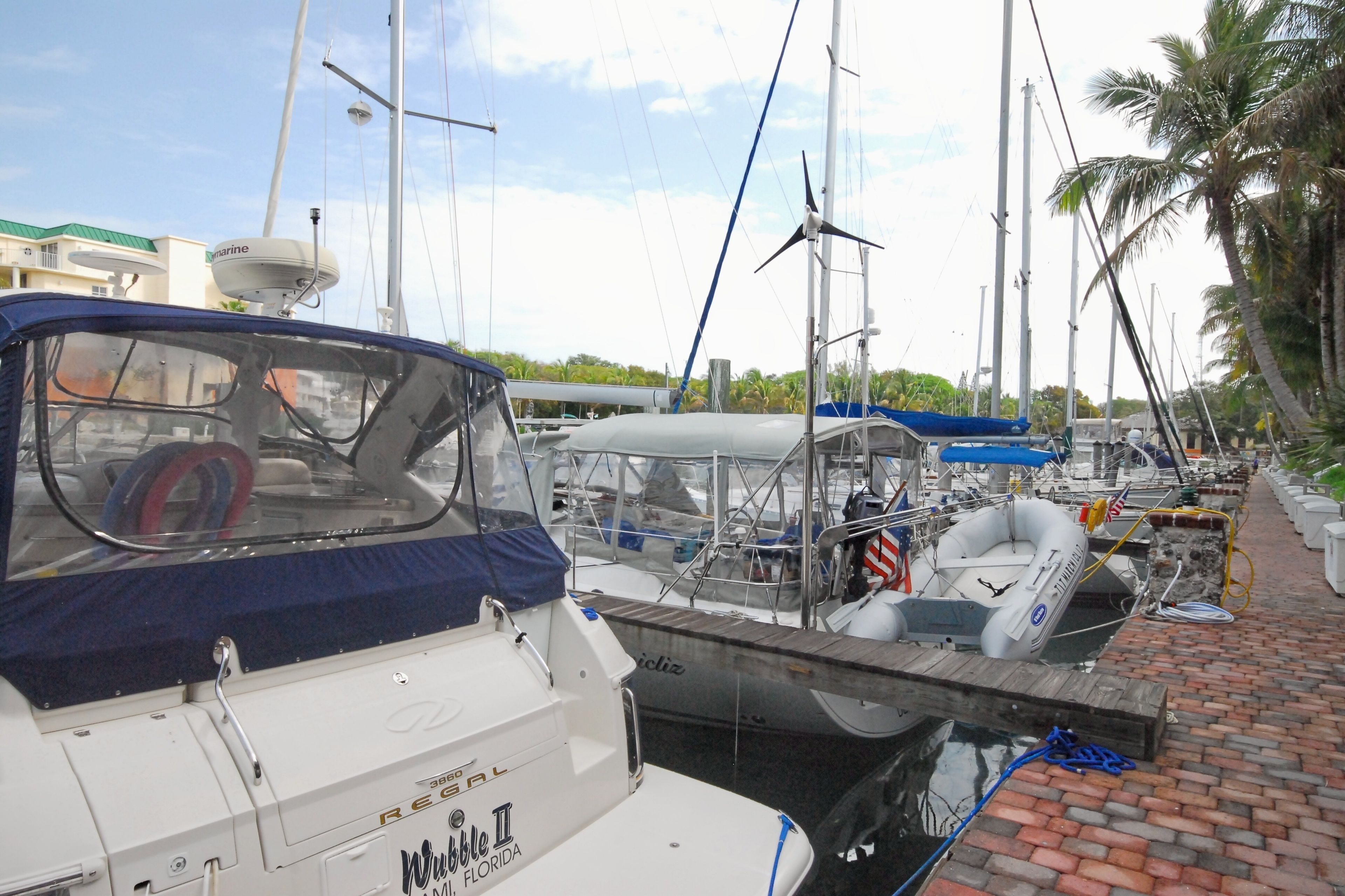 A marina with boats docked, including a white boat with 'Regal' and 'Willett II' visible.