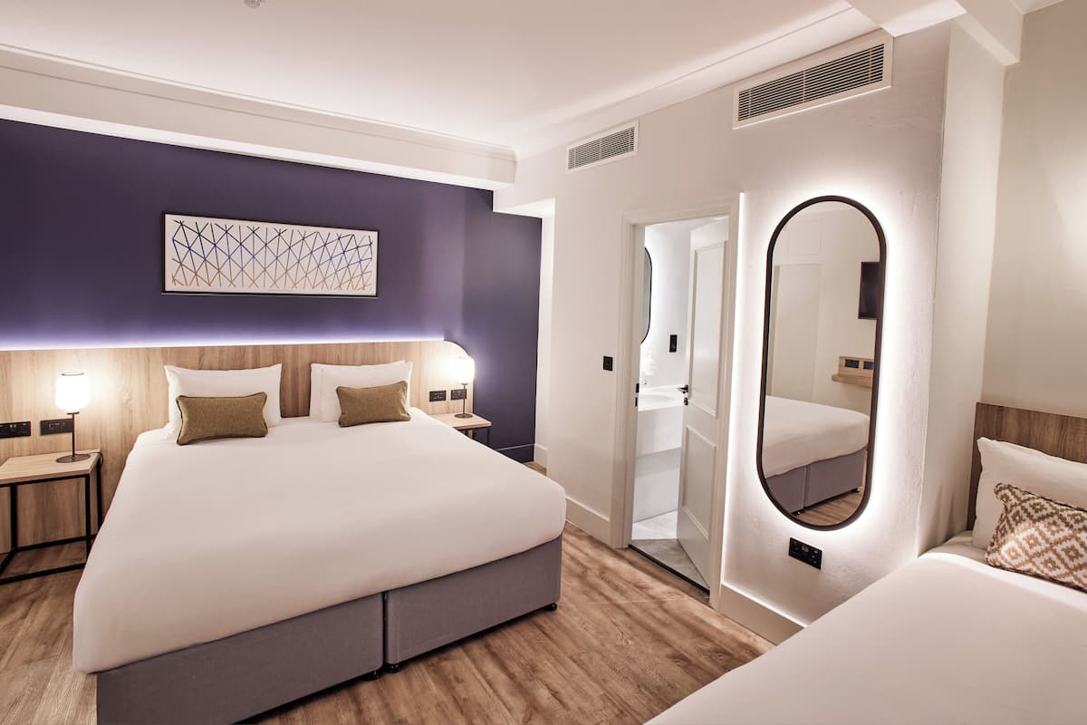 Deluxe Family Room | In-room safe, desk, laptop workspace, iron/ironing board