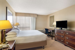 Premium bedding, desk, laptop workspace, blackout curtains