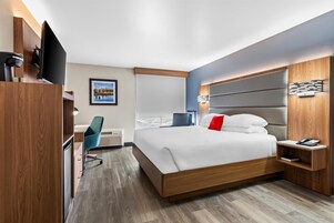 Premium bedding, desk, laptop workspace, blackout drapes