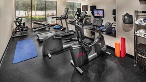 A gym with cardio machines, weights, and a blue mat. - Holiday Inn Atlanta-Northlake by IHG (Atlanta)