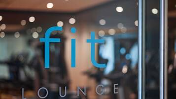 A blurred interior of a fitness center with the text 'fit lounge' visible.