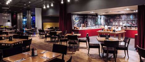 A restaurant with wooden tables and chairs, a bar area, and a mural on the wall.