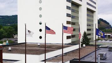 A hotel with multiple flags, including the American flag, and a sign that reads "DOUBLEX BY HILTON".