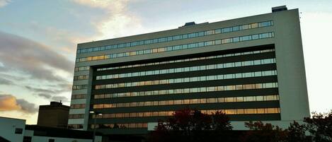 A modern building with multiple floors and large windows.
