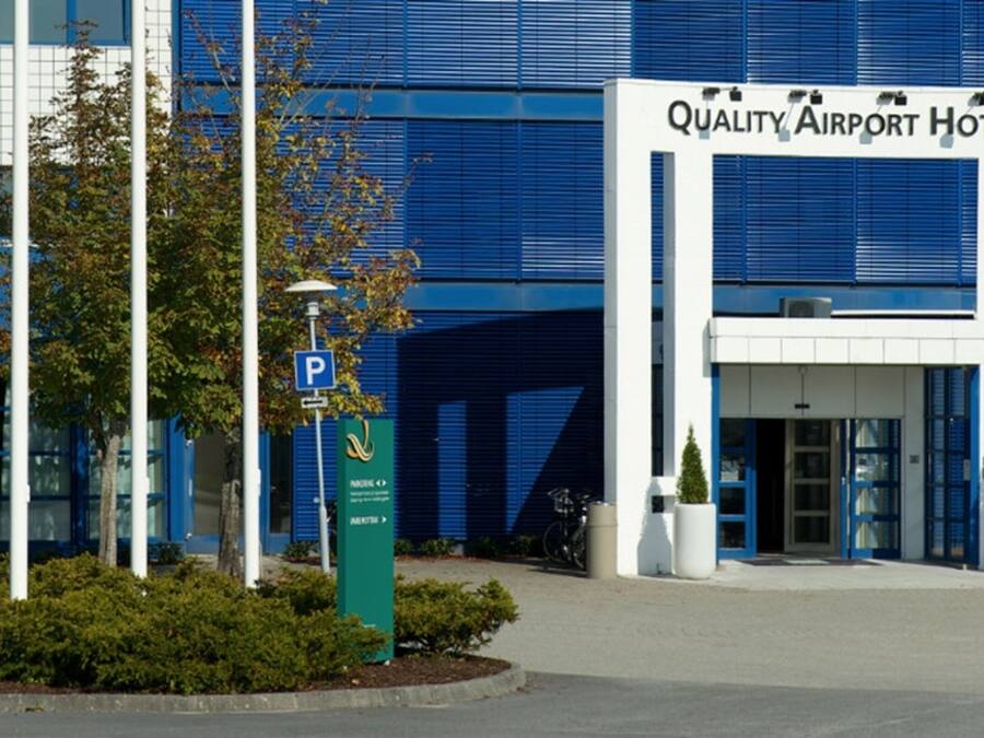 A building with a sign reading "Quality Airport Hotel".